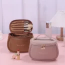 Open leather cosmetic bag showing organized makeup brushes and skincare bottles inside partitioned slots.