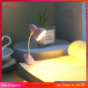 Compact warm mini lamp clipped onto a paperback book page providing bright glare-free reading light.