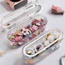 Transparent acrylic storage box for organizing hair ties, headbands, and small household items on a desktop.