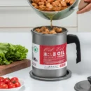1.4L stainless steel oil strainer pot and grease container with fine mesh filter on a kitchen counter.