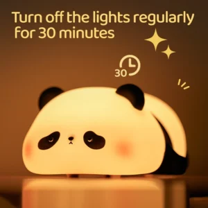 Cute silicone panda lamp glowing with warm dimmable light on a cozy bedside table.
