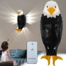 Modern 3D eagle lamp wall projector emitting creative atmosphere lighting in a dark room.
