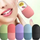 Pink silicone ice roller being applied gently to a person's cheekbone for a cooling facial treatment.