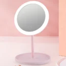 Dimmable LED cosmetic mirror with rotating stand and USB charging port for makeup application.
