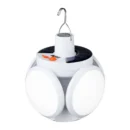 Foldable soccer-shaped solar LED bulb illuminating an outdoor night market stall.