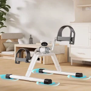 Black portable mini under-desk exercise bike being pedaled by a person sitting in an office chair.