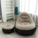 Flocked inflatable sofa with a matching leg rest footstool set up on a beautiful sandy beach.