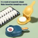 Bright white manual dumpling maker dough press mold sealing a perfect pastry on a flour-dusted kitchen counter.