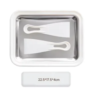 Bright blue rectangular rolled ice cream maker pan with two plastic scrapers rolling up fresh strawberry ice cream on a kitchen table.