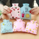 Small pink pocket-sized mini hot water bag with a secure leak-proof screw cap resting on a soft cozy blanket.