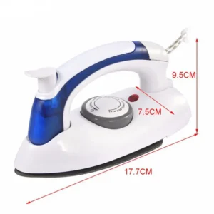 Compact blue folding iron with its handle tucked down flat sitting next to a packed travel suitcase.